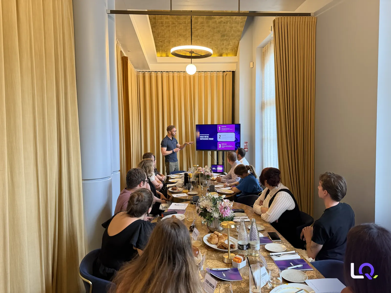 Luke Quilter presenting a slide on autonomous travel planning at the AI search breakfast